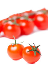 Juicy organic Cherry tomatoes isolated over white background