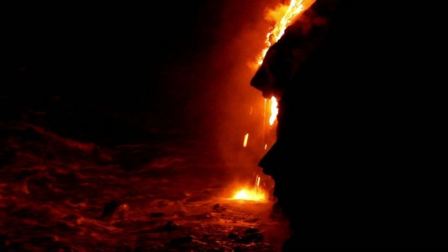 Lava flow at night in to the sea