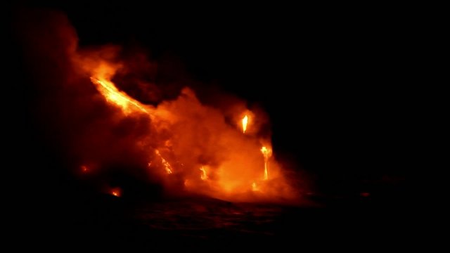 lava flow at night into the sea