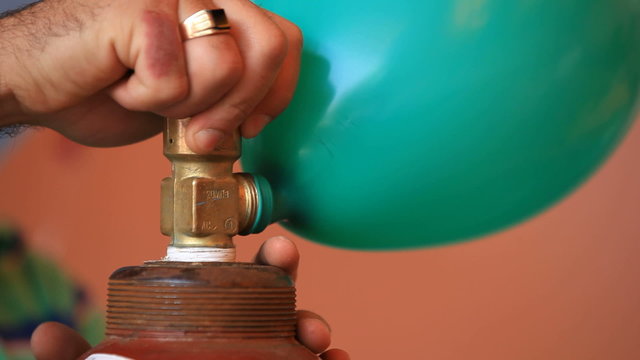 Inflating a balloon with helium. Close-up