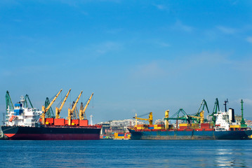 Fototapeta premium cargo ships with cranes.