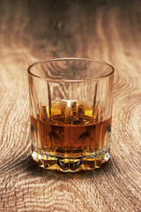 whiskey in glasses on wooden