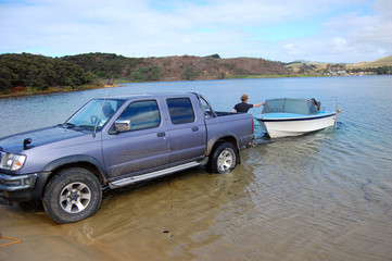 Car with boat trailer at lake