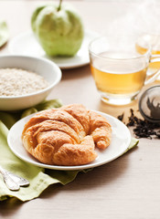 healthy breakfast: croissant, porridge and green tea