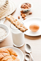 Fototapeta na wymiar healthy breakfast: croissant, porridge, almonds and milk