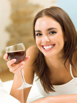 Young woman with glass of redwine