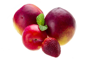 Ripe bright peaches, plum, strawberry and mint