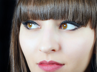 Portrait of a young beautiful woman with bangs in studio