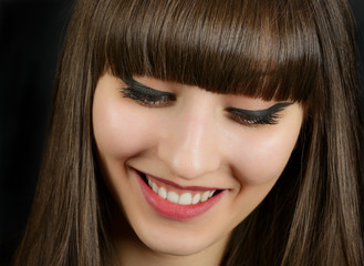 Portrait of a young beautiful woman with bangs in studio