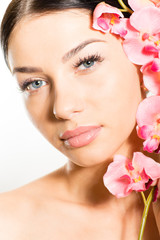 Beautiful girl face & pink flowers, perfect skin & lips.
