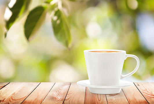 Cup of hot drink on summer background, free space for text