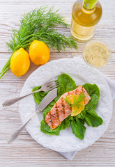 grilled salmon fillets on spinach