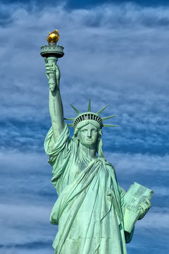 Statue of liberty close up vertical isolated in blue background