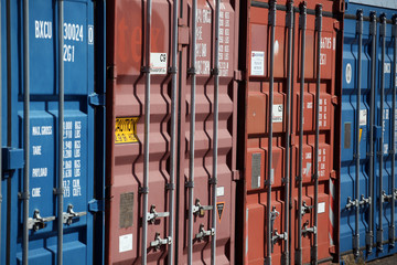 Blue and red cargo containers locked