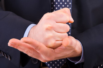 Businessman gesturing with both hands.