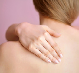 Fototapeta premium Woman with hand on shoulder. Focus is on a hand