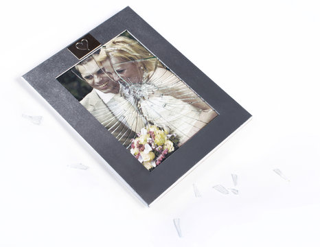 Broken photo frame of married couple