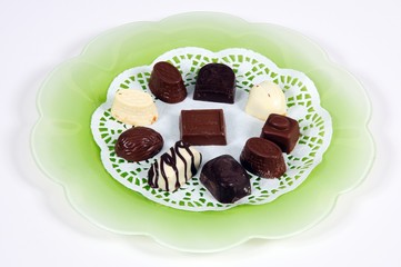 Belgian chocolates on green plate © Arena Photo UK