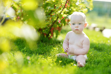 Baby sitting on a green grass