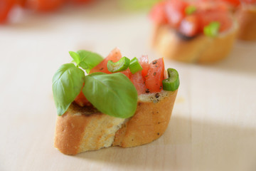 Geröstete Weißbrotscheibe mit Tomaten und Basilikum