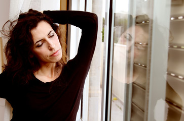 Fototapeta na wymiar Portrait of beautiful woman near the window