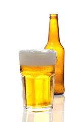bottle and glass with beer on white background