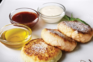 Cheese pancakes with jam and cream