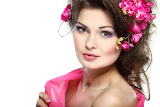  beautiful  brunette with pink orchids in hairs, cosmetics
