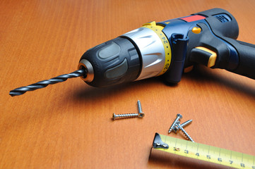 drill with roulette on wooden below