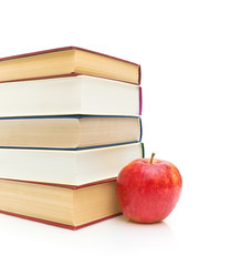 books and apple isolated on white background