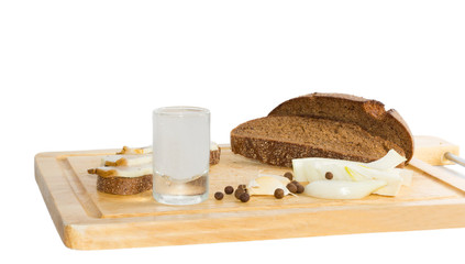 Brown bread slices, vodka shot glass and some lard.