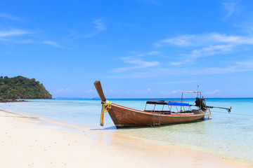 Naklejka na ściany i meble Boat on the beach with blue sky