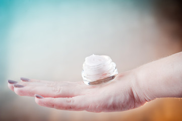 Woman's hand with skin care cream