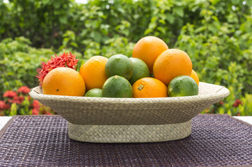 Fresh citrus fruits in basket with selective focus