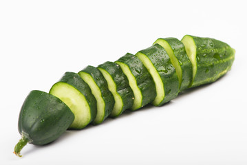 The cut cucumbers on a white background