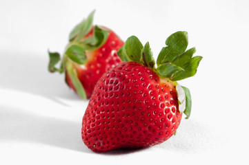 Two strawberries isolated on white background