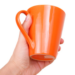 Female hand with orange teacup