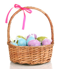 Colorful easter eggs in basket isolated on white