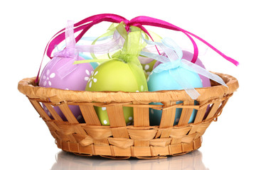 Colorful easter eggs in basket isolated on white