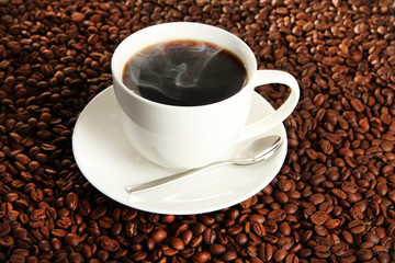 Cup of coffee on coffee beans background