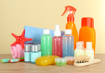 Hotel amenities kit on table on beige background