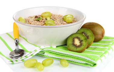 Useful oatmeal in bowl with fruit isolated on white