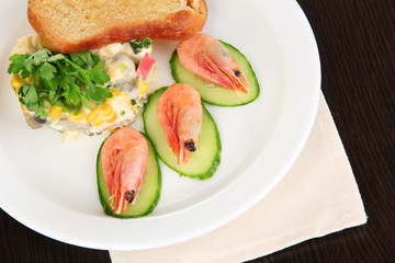 Small portion of food on big plate on wooden table