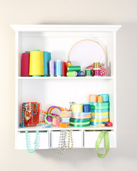 Beautiful white shelves with thread and material for