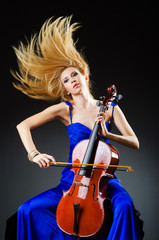 Fototapeta na wymiar Attractive woman with cello in studio