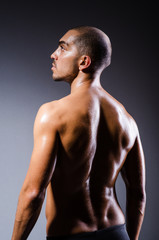 Fototapeta premium Muscular man in dark studio