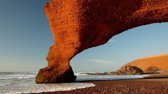Red archs on atlantic ocean coast. Morocco