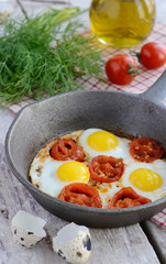 Breakfast with fried quail eggs with cherry tomatoes