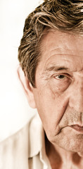 Elderly closeup sad man's face over white background