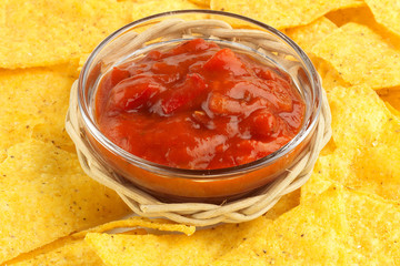 bowl of hot sauce on background of nachos